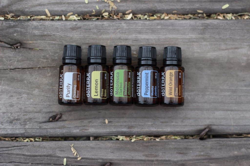 bottles of DoTERRA oils: Purify, Lemon, Melaleuca, Peppermint, Wild Orange