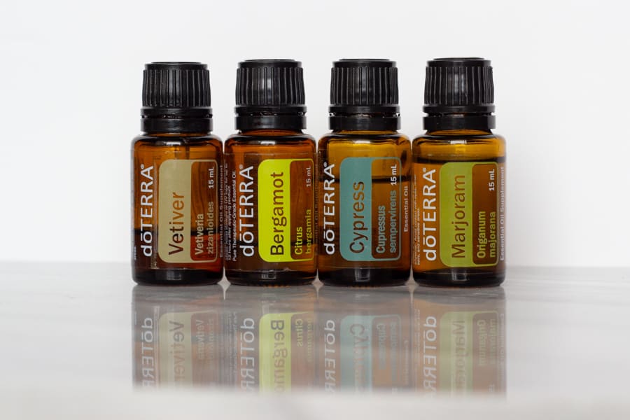 bottles of doterra vetiver, bergamot, cypress, and marjoram: the oils used in Rain Room Spray